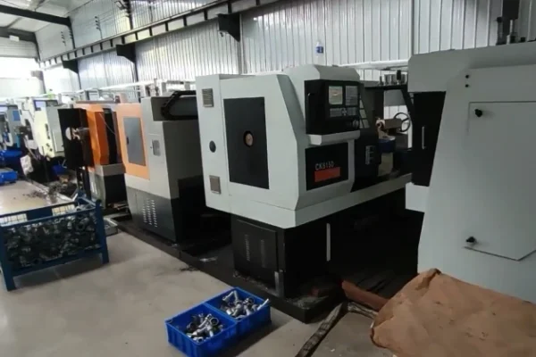 ‌A row of ss hose fittings processing machines in a clean and efficient factory