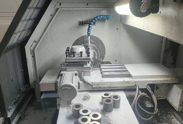 A machine dedicated to manufacturing stainless steel fittings operates precisely, producing customized connectors tailored to industrial specifications
