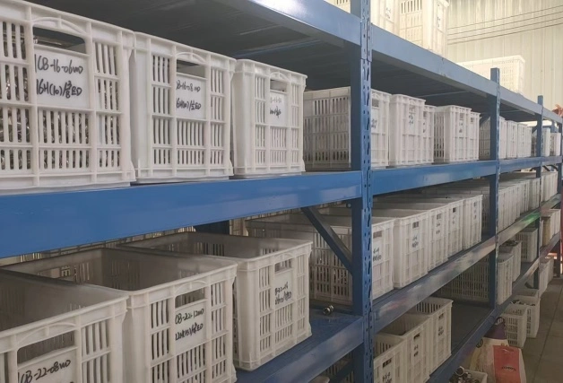 A shelf fully stocked with baskets of stainless steel fittings, demonstrating rapid production capacity